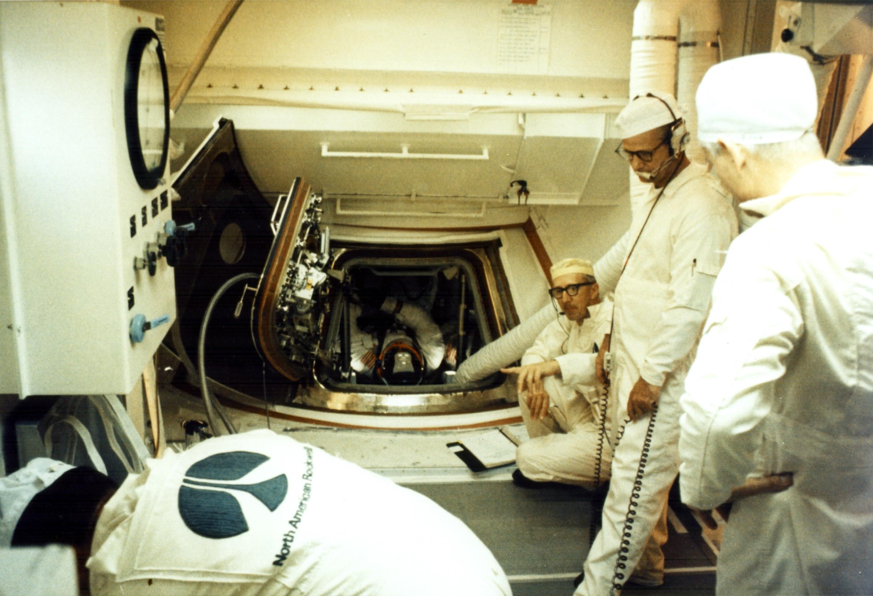 The Apollo 11 launch team rising from their consoles in Firing Room 1 to watch the liftoff through the window — JoAnn Morgan seated, left of center, third row