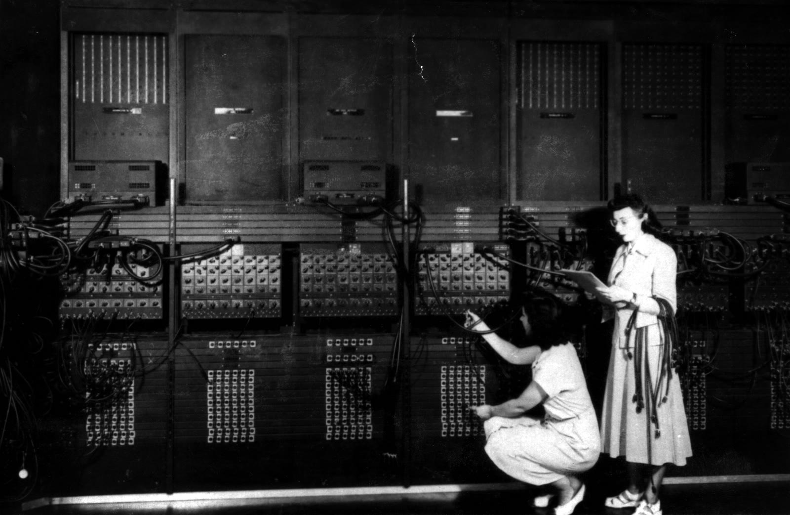 Two ENIAC programmers replugging the machine's patch cables to set up a new computation