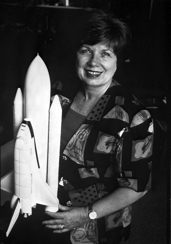 JoAnn Hardin Morgan posing with a model of the space shuttle