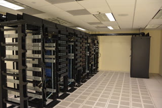 Server racks in a datacenter. Photo by Trique303, CC BY-SA 4.0.