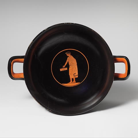 Interior of an Attic red-figure kylix, ca. 460 BCE: a youth carrying writing tablets — a schoolboy of Socrates' generation. Metropolitan Museum of Art, Open Access (CC0).