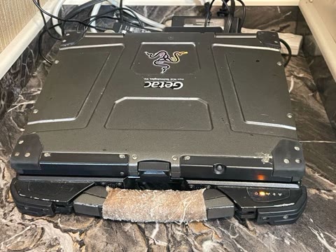 Closed and ready to carry — the Getac badge on a magnesium-alloy lid. Photograph by Rocky L. Oliver.