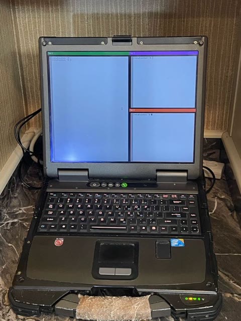 TitaniumWM live — xterm split panes and the color-coded tab bar, running on the Getac B300-X. Photograph by Rocky L. Oliver.