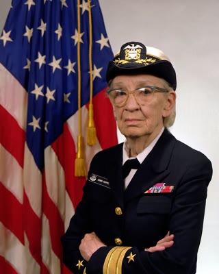 Grace Hopper in her Navy uniform — she built the first compiler