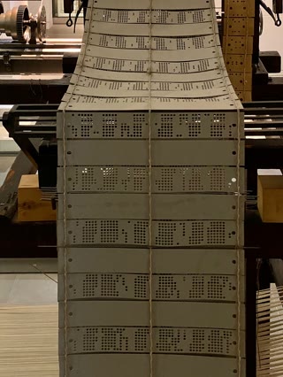 Chained Jacquard cards — each card is one pass of the shuttle; the loop is the program