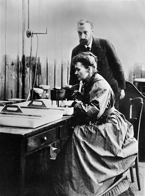 Marie and Pierre Curie at work in their Paris laboratory — the shed where, stirring tons of pitchblende by hand, they isolated polonium and radium (Wellcome Collection, CC BY 4.0).