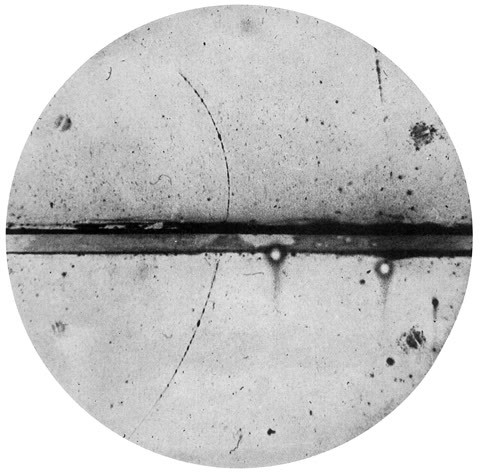 Anderson's cloud-chamber photograph, 1932 — the curved track curving the wrong way through the lead plate: the positron, antimatter discovered in a photograph. Dirac's equation had predicted it four years earlier (Carl D. Anderson, public domain).