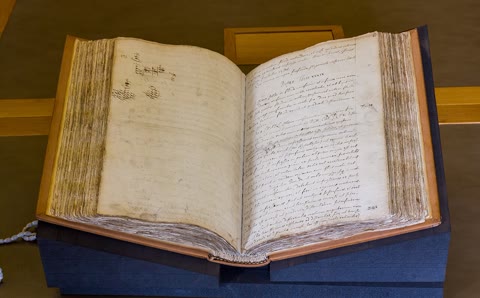 A page of Newton's own manuscript for the Principia, held at the Royal Society — the handwriting that unified terrestrial and celestial mechanics into one law (photographed at the Royal Society, public domain).