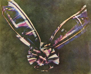 The tartan ribbon — the world's first permanent color photograph, taken by Maxwell and photographer Thomas Sutton in 1861 by superimposing three filtered exposures (public domain).