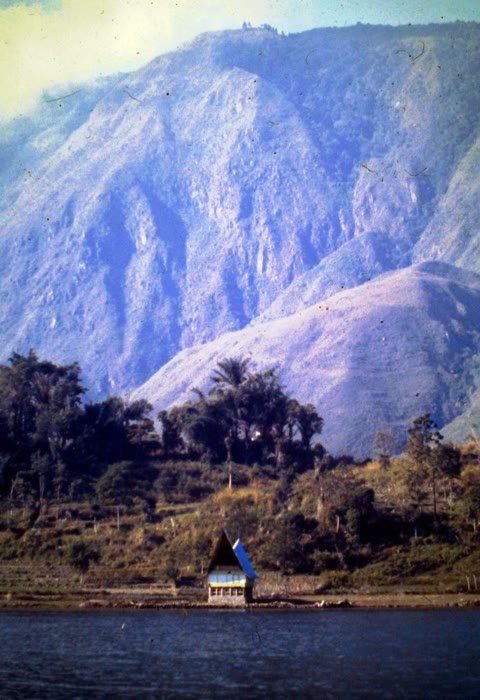 Samosir Island, inside Lake Toba — not a normal island but the caldera's resurgent dome, still being pushed upward by the magma chamber below (John Hill, CC BY-SA 3.0).