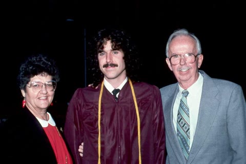 Davis at his Arizona State University graduation, flanked by his parents — the National Merit Scholar the system still remembered. Public domain.
